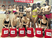 COLD COMFORT: Youths in Shenzhen, China prepare for a strip-off challenge in opposition to the water-wasting ice-bucket rage