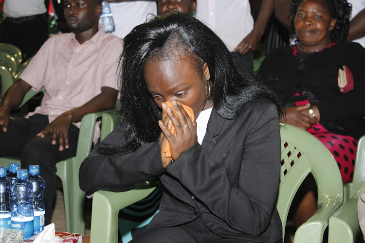 A mourner is overcome with grief