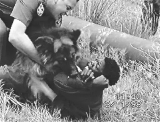 BRUTAL: A Special assignment video footage SHOWS AN East Rand SAPS dog unit MEMBER torturing AN alleged illegal immigrant as part of a training exercise. The video is littered with racist REMARKS. PHOTO: SABC