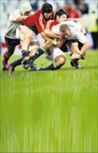 BLOEMFONTEIN, SOUTH AFRICA - JUNE 06, Meyer Bosman of the Cheetahs stopped by Stephen Ferris and James Hook of the British & Irish Lions during the British and Irish Lions Tour match between Cheetahs and British and Irish Lions from Vodacom Park on June 06, 2009 in Bloemfontein, South Africa.Photo by Duif du Toit / Gallo Images