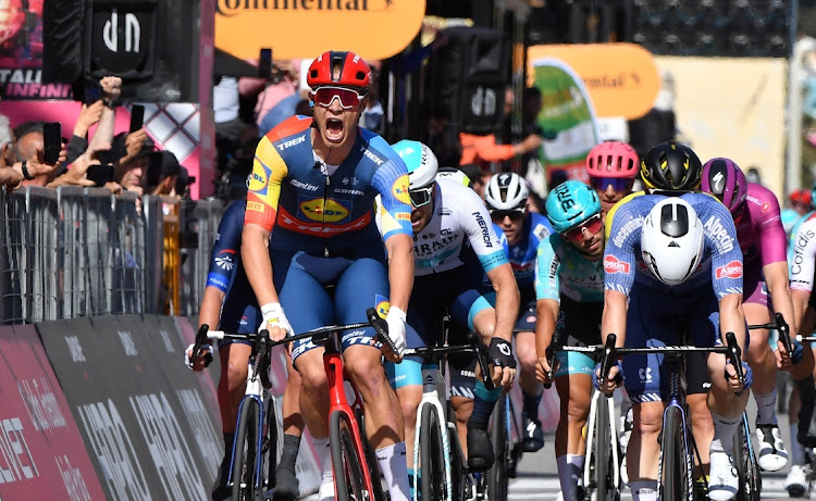 Jonathan Milan celebrates as he crosses the finish line to win stage 4 at the Giro d'Italia in Italy, May 7 2024. Picture: REUTERS/JENNIFER LORENZINI