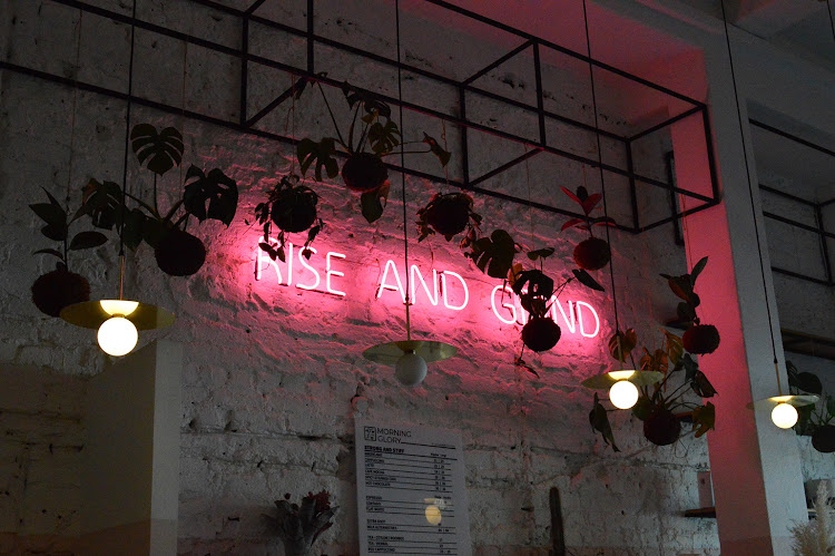 "Rise and grind" neon sign at Morning Glory.