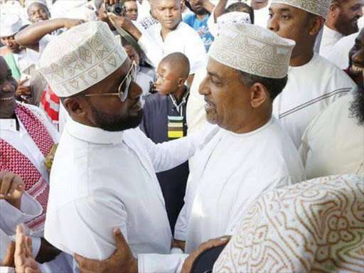 Governor Hassan Joho with Suleiman Shabhal during Eid prayers in Mombasa, June 26, 2017. /NORBERT ALLAN