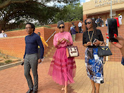 Businesswoman and beauty pageant title holder Basetsana Kumalo leaves the Randburg magistrate's court with  friends. 