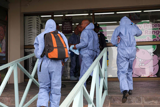 FAMILIAR SCENE: Bomb squad at the crime scene in Vincent plastic warehouse following bombing of the safe Picture: MICHAEL PINYANA