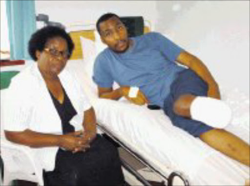 SHOCKING ORDEAL: Sphephelo Nkabinde and his mother, Goodness, at a Durban hospital where he is recovering after being shot. Pic. Mhlaba Memela. 15/05/08. © Sowetan.