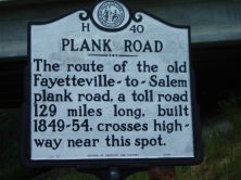 The route of the old Fayetteville-to-Salem plank road, a toll road 129 miles long, built 1849-54, crosses highway near this spot.Plaque via North Carolina Highway Historical Marker Program, and is...
