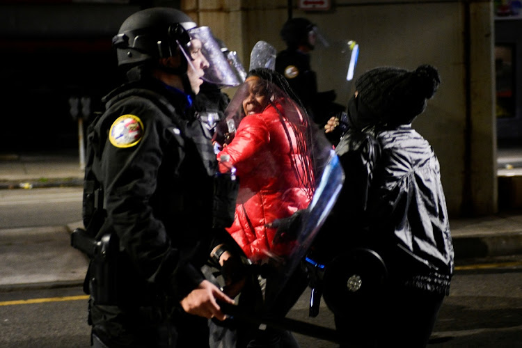 Demonstrators clash with riot police during a rally after the death of Walter Wallace Jr., a Black man who was shot by police in Philadelphia, Pennsylvania, U.S., October 27, 2020.