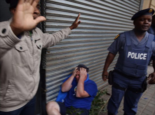 DA protester was attacked by pro-Zuma supporters Picture: ALON SKUY
