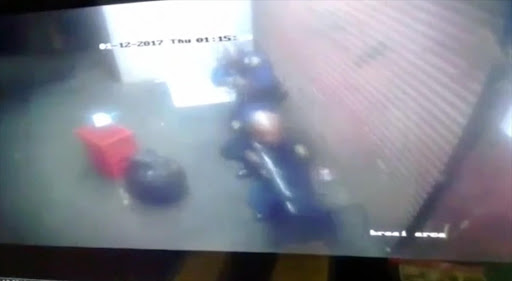 A police officer is seen on CCTV footage in the moment before he shoots his colleague in the back of the head during a robbery.