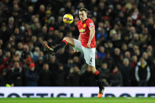 English defender Phil Jones controls the ball during the English Premier League football match between Manchester United and Southampton at Old Trafford in Manchester, north west England, on January 11, 2015. AFP PHOTO / OLI SCARFF