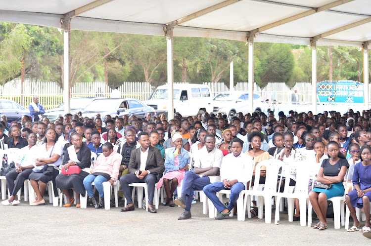 Students from the School of Health Sciences of Kenyatta University follow proceedings during the memorial service of their 11 colleagues who died in a road accident on Monday at Maungu in Voi on March 24