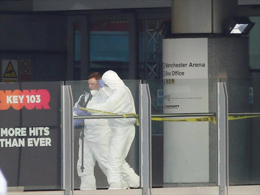 Forensics investigators work at the entrance to the Manchester Arena, Britain, following a blast, May 23, 2017. /REUTERS