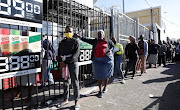 People queue for liquor in Nyanga, Cape Town.
