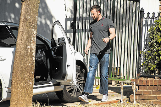 WORRIED MAN: A grim-looking Oscar Pistorius arrives at the home of his uncle Arnold in Pretoria on Thursday. He will learn his fate in his murder trial this week Picture: WALDO SWIEGERS