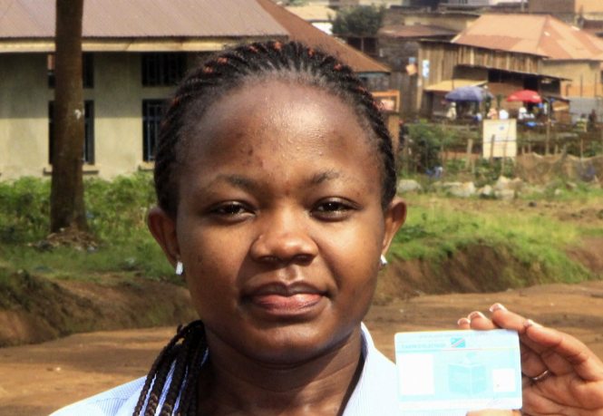 Stephanie Mbafumoja, a Congolese law student holds her voter identity card in L'avenue de L'itav in Butembo, North Kivu province, Democratic Republic of Congo, February 9, 2024. REUTERS/Yassin Kombi