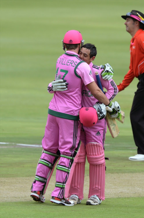 Quinton de Kock with AB de Villiers in a pink strip to improve breast cancer education and awareness.