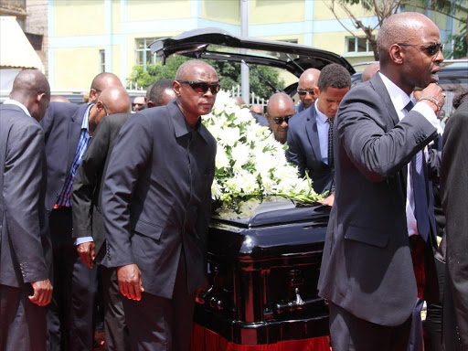 Pall bearers carry the remains of the late politician into the Stadium./ALICE WAITHERA