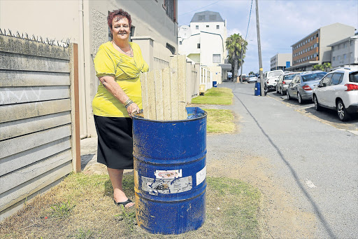 TRASH TALK: Quigney resident Beverley Lottering got so fed up with garbage clogging up the gutters around her Inverleith Terrace home that she acquired eight old drums and dotted them around her neighbourhood in an effort to clean up the neglected area Picture: STEPHANIE LLOYD