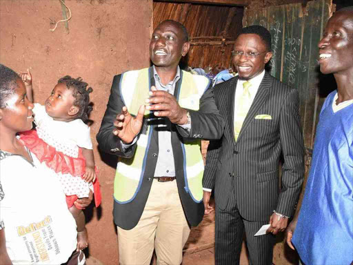 Deputy President William Ruto and Budalang'i MP Ababu Namwamba at the house of Geoffrey Msafiri in Port Victoria, where the DP launched the government's Last Mile Connectivity Programme, December 2, 2016. /EMOJONG OSERE
