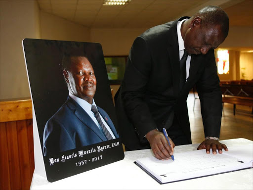 Deputy President William Ruto signs a condolence book at the late Kitui West MP Francis Nyenze's memorial service at CITAM, Karen on Friday, December 15, 2017. /DPPS