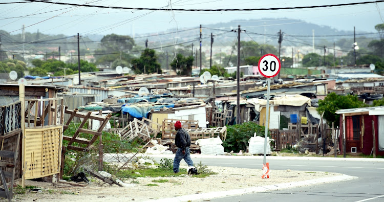 LIVING ON THE EDGE: An elderly man walks in Airport Valley, Walmer Township. Municipal officials handed out sanitiser, gloves, soap and masks to people in the area on Tuesday as part of a hygiene awareness drive