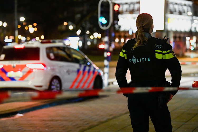 A police officer stands near an Apple store in central Amsterdam during a hostage incident in the store, in Amsterdam, Netherlands February 22, 2022.