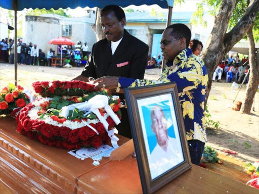 Wiper leader Kalonzo Musyoka and Mwingi Central MP Gideon Mulyungi lay a wreath at the casket of political activist and businessman the late Mzee Paul Mutemi during his burial at his farm in Enziu, Mwingi Central, Kitui on April 28, 2018. /DENNIS KAVISU