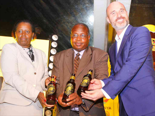 From Left KBL Marketing & Innovations Director John Williams, KBL MD Jane Karuku and Rio 2016 Team Kenya Chef De Mission Steve Arap Soi display the new Tusker Gold Limited Edition beer at the launch of the Tusker Twende Rio Campaign at the Kenya National Theatre yesterday. Part of the proceeds from the sale of the Tusker Gold Edition will go towards supporting Team Kenya on the Road to Rio.d.REUTERS