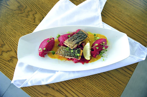 A spot of colour: Sea bass served with a splash of purple mash.