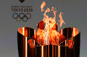 The celebration cauldron is lit during the opening ceremony ahead of the the first day of the Tokyo 2020 Olympic torch relay at the J Village during the Tokyo Olympic Games torch relay on March 25, 2021 in Naraha, Fukushima, Japan. 