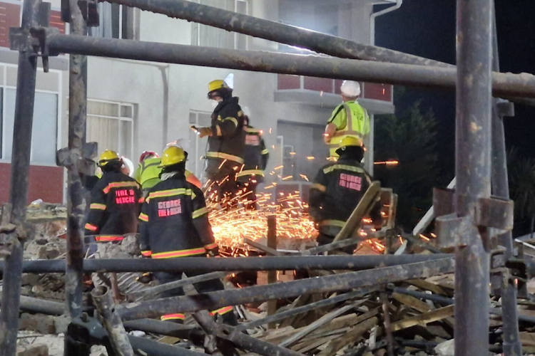 Rescue workers at the collapsed multistorey building under construction in Victoria Street, George.