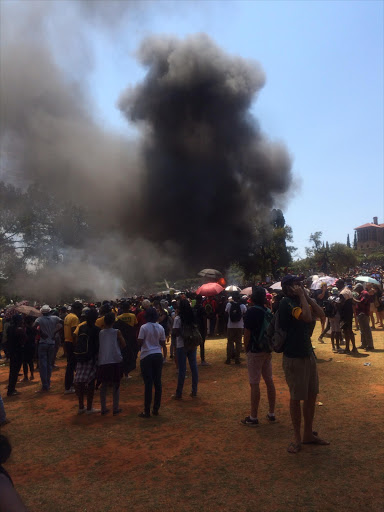 Students from South Africa's universities converge on the Union Buildings in Pretoria in support of the #FeesMustFall movement. Inside the building there is a meeting between President Jacob Zuma and student leaders. The students began burning tyres, burning one of the trees on the grounds.