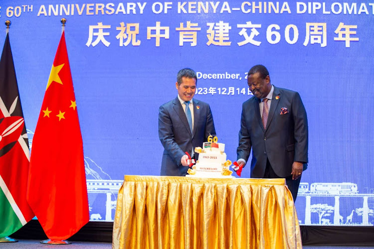 Prime Cabinet Secretary and Foreign Affairs CS Musalia Mudavadi cuts the cake with Chinese envoy to Kenya Zhou Ping during celebrations to mark 60 years of Kenya-China relations, Nairobi, December 18, 2023.