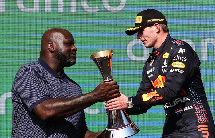 Race winner Max Verstappen of the Netherlands and Red Bull Racing celebrates on the podium with NBA legend Shaquille O'Neal during the Formula One Grand Prix of USA at Circuit of The Americas on October 24, 2021 in Austin, Texas.