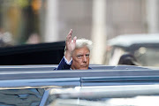 Former US president Donald Trump gestures on the opening day of the hush money criminal trial outside Trump Tower in New York on April 15, 2024.