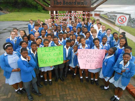 SHOWING SUPPORT: Gonubie Primary Grade 7 pupils made their feelings known last Friday after a concerned member of the public taped shut the Gonubie boardwalk fearing a child could get hurt while using the neglected walkway Picture: SUPPLIED