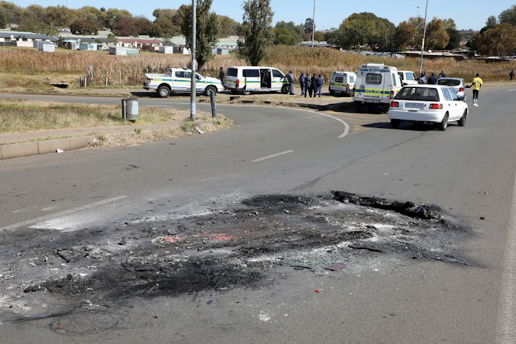 Ashes remain on the roads leading to Nancefield Hostel in Soweto where four cars were burnt during a protest over electricity on Saturday May 8 2021.