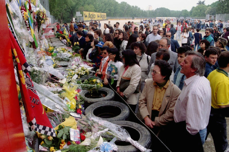 Fans of Ayrton Senna lay flowers at the Tamburello bend, where the Formula 1 racing champion was killed at the San Marino Grand Prix in 1994. File photo: REUTERS/STRINGER