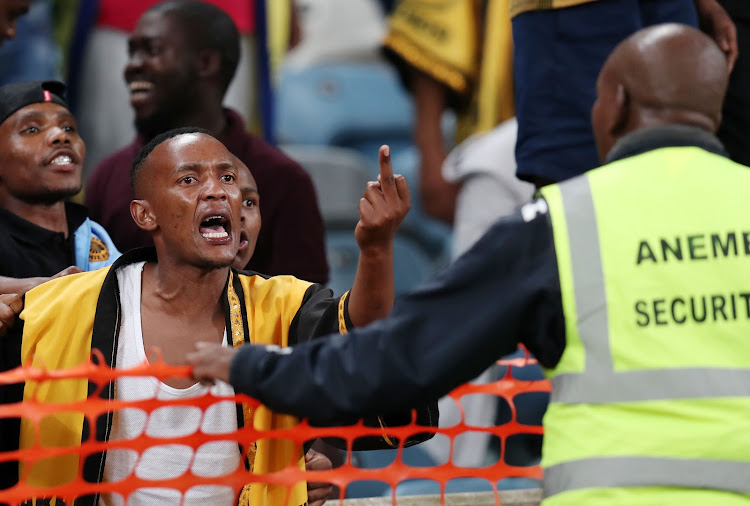 A Kaizer Chiefs fan in a confrontation with a security officer at Moses Mabhida Stadium in Durban on April 21 2018.