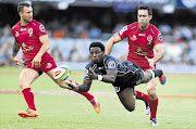 ON THE FLY: Lwazi Mvovo of the Sharks gets a diving pass away during the Super Rugby match against the Reds at King's Park yesterday Picture: GALLO IMAGES