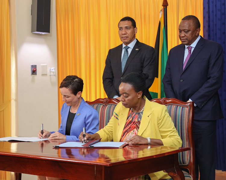 President Uhuru Kenyatta and Jamaican Prime Minister Andrew Holness witness the signing of agreements at the Jamaican Prime Minister's Office in Kingston, Jamaica on August 6, 2091.