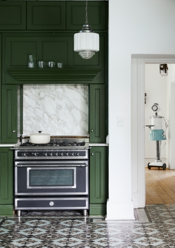 A dark green in this traditional kitchen adds to the old-school appeal of the house, while giving it a contemporary twist.