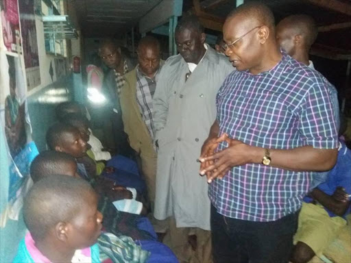 Funyula MP Paul Otuoma (r) at Kocholya district hospital in Teso North subcounty where ten pupils who sustained injuries after a lightning strike were admitted on September 27, 2016. /COURTESY