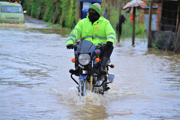 A boda boda rider along the flooded Syokimau-Katani road in Machakos County on Sunday, April 21, 2024.