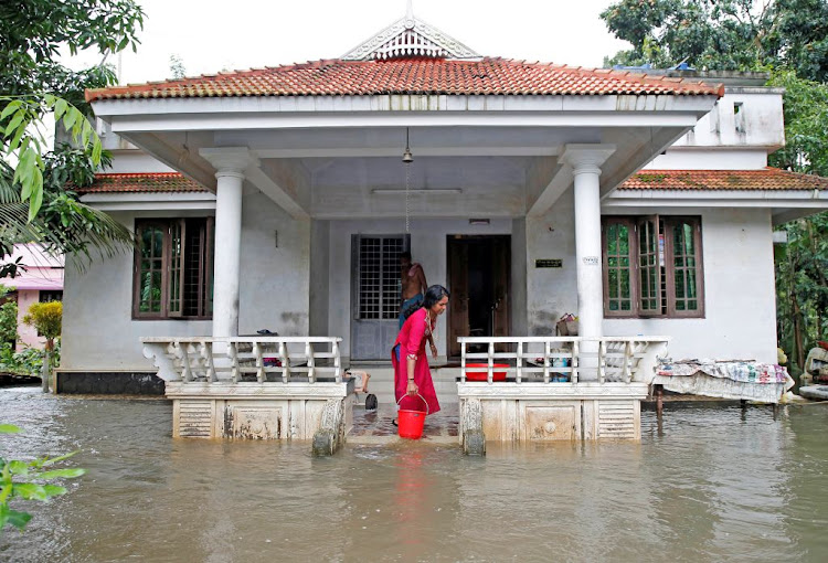 A woman clears out the water from her flooded house at Paravur on the outskirts of Kochi, in the southern state of Kerala, India, on August 11 2019.