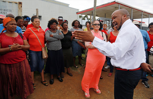 Irvin Jim addresses some of the dismissed workers at Lear Corporation on the West Bank PICTURE ALAN EASON