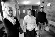 20090601VNH.  Smilling Virginia Tiny Makopo, 28, (white top) inside the Sebokeng magistrates' court. Makopo, a former domitory parent at the Oprah Winfrey Academy for Girls in the Vaal who is faincg charges ranging from sexual and physical abuse.PIC:VELI NHLAPO .01/06/2009. © SOWETAN.