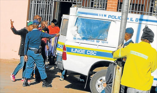 DAY AT THE OFFICE: Police make arrests during an anti-crime operation in East London