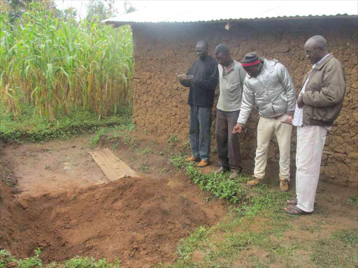 Residents of Bukembe in Kanduyi, Bungoma county, next to the shallow grave in which Jared Nyongesa's wife was buried, July 14, 2018. /BRIAN OJAMAA
